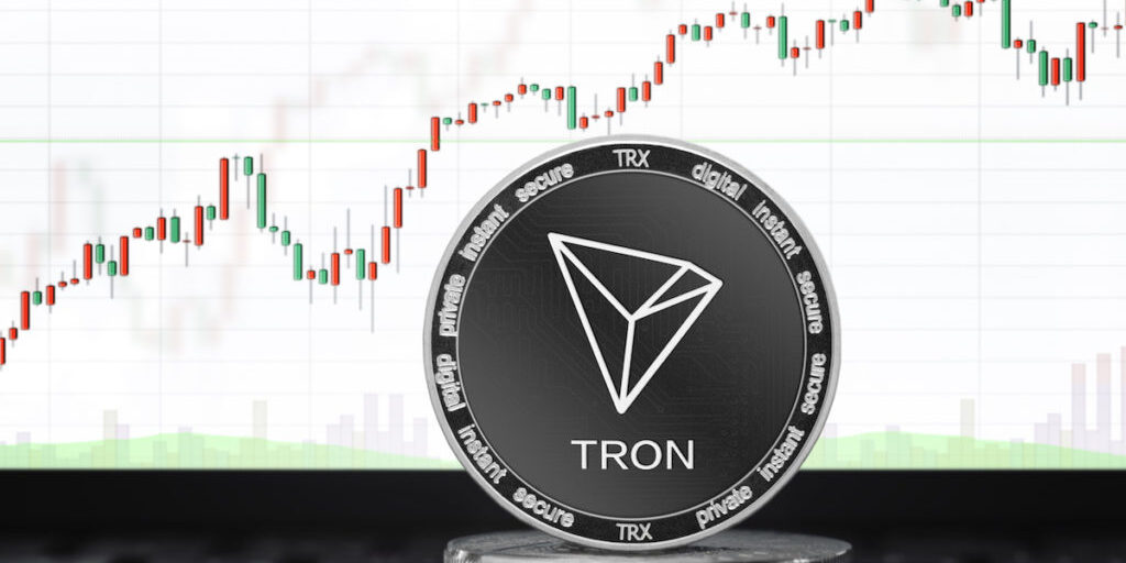 TRON (TRX) cryptocurrency; physical concept tron (tronix) coin on the background of the chart