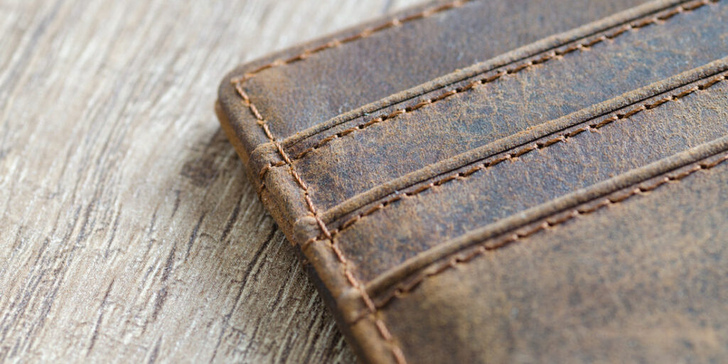 Leather wallet on wooden table